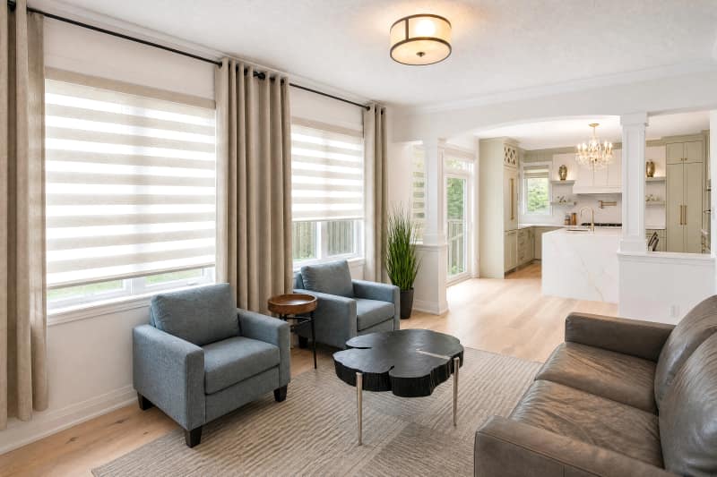 Same living room after editing, with the window view recovered and the interior evenly exposed